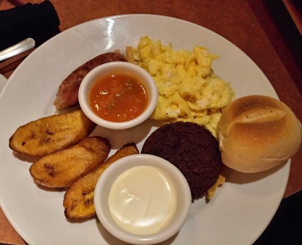 Traditional Salvadoran breakfast dish with black beans, rice, and more